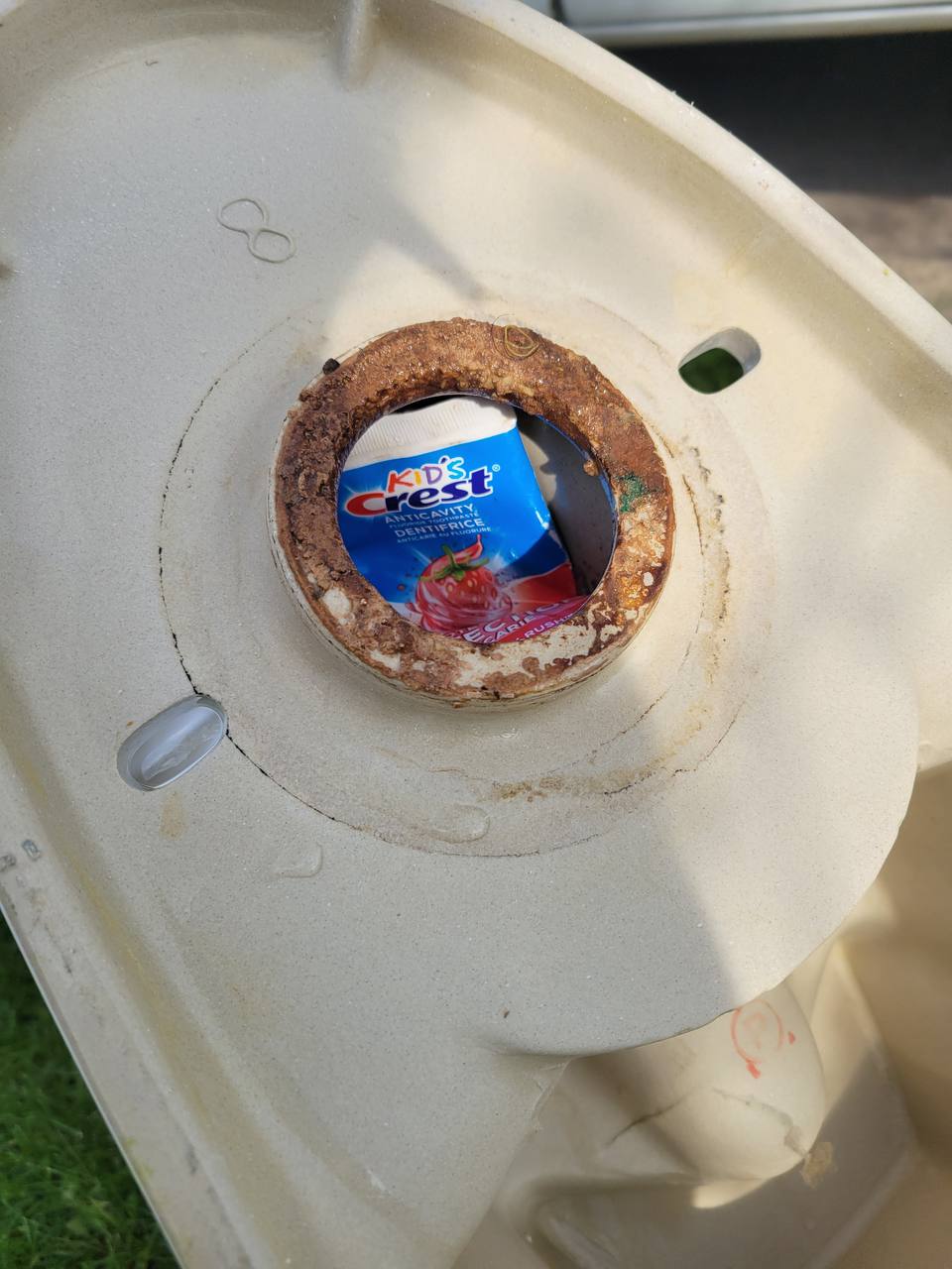 Toilet tank with hard-water mineral scale and rust buildup found on a Niagara Region service call